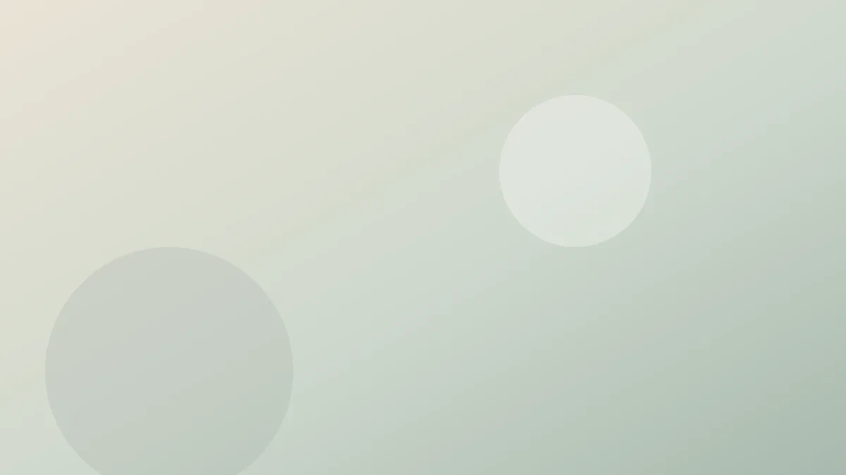 A pair of wooden chopsticks resting on a ceramic rest beside a white bowl of rice on a plain table.